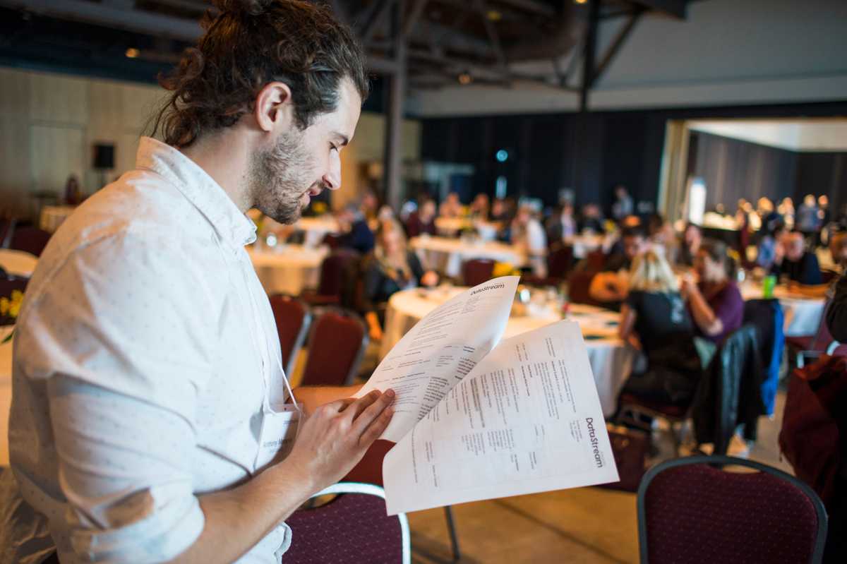 A man looks through some papers at the event