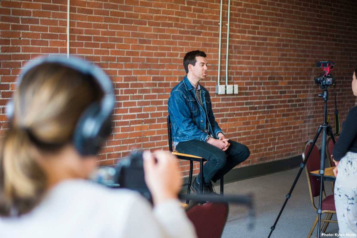 Donald Killorn of Eastern Charlotte Waterways sitting on a chair as he is being filmed during an interview